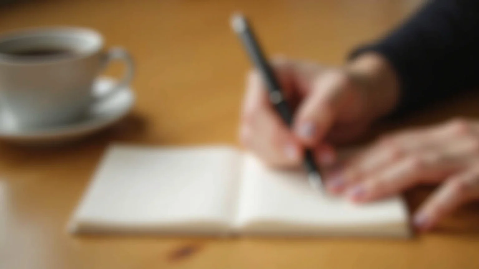 AI agent vs custom GPT comparison notes in a paper notebook with laptop showing chat interface, natural light, candid workspace