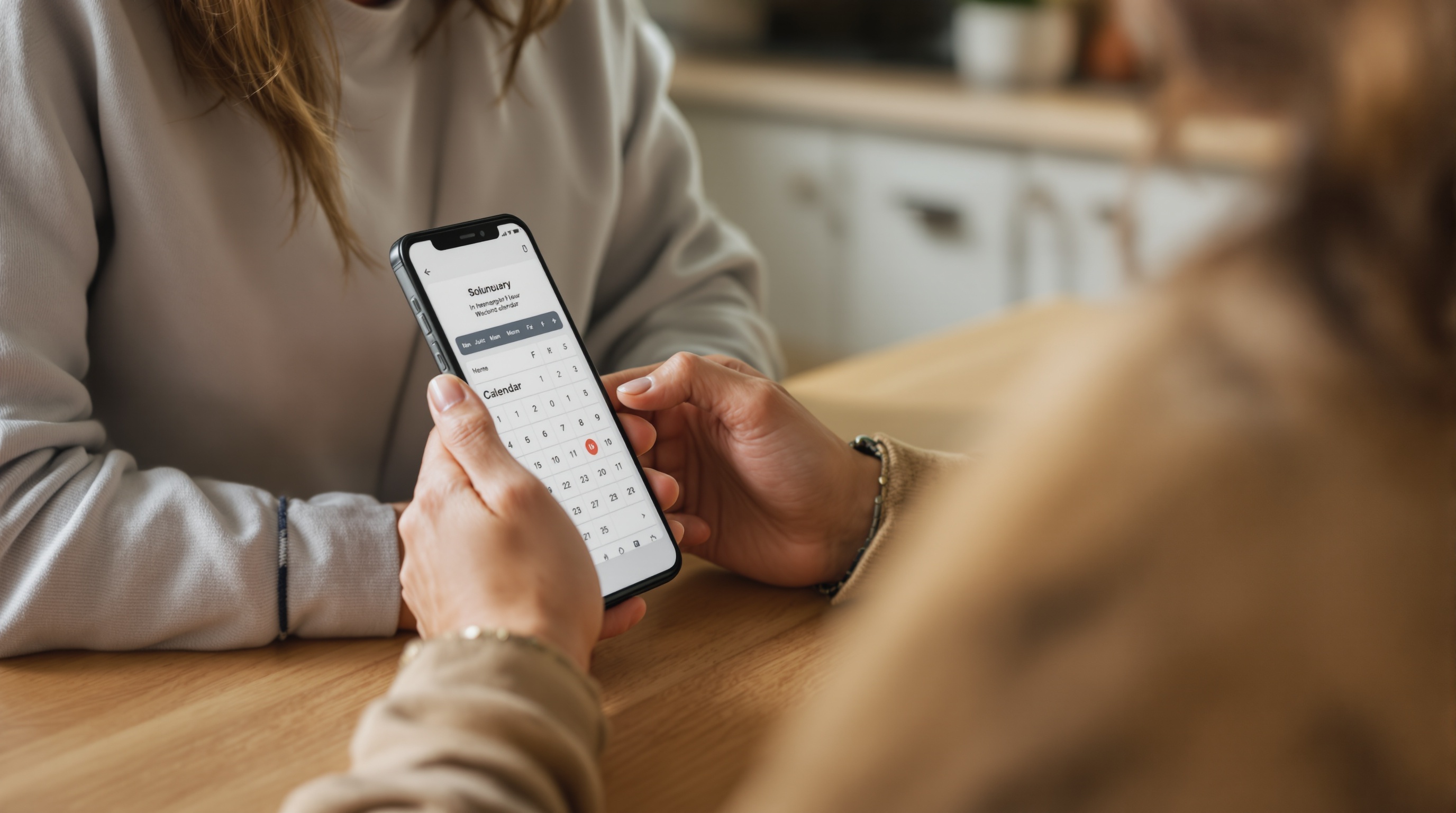 solopreneur checking tasks on her phone in the kitchen